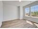 Bright bedroom features hardwood floors, large windows, and ample natural light at 623 Leafy Branch Way, Mcdonough, GA 30253