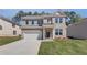 Charming two-story brick home features a covered entryway and a two-car garage at 623 Leafy Branch Way, Mcdonough, GA 30253
