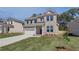 Lovely two-story brick home with an attached two-car garage and green lawn at 623 Leafy Branch Way, Mcdonough, GA 30253