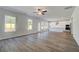Open living area featuring modern kitchen with stainless appliances and center island, wood floors, and natural light at 623 Leafy Branch Way, Mcdonough, GA 30253