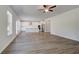 Modern open kitchen with white cabinets, stainless steel appliances, an island, and wood floors at 623 Leafy Branch Way, Mcdonough, GA 30253