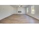 Spacious living room with wood floors, a modern fireplace, and large windows that bring in lots of light at 623 Leafy Branch Way, Mcdonough, GA 30253