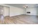 Open-concept living room featuring wood floors, a modern fireplace, and lots of natural light at 623 Leafy Branch Way, Mcdonough, GA 30253