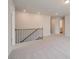 Upstairs loft with neutral carpet and railing that overlooks the stairwell at 623 Leafy Branch Way, Mcdonough, GA 30253