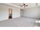 Spacious main bedroom features a ceiling fan and light gray carpet at 623 Leafy Branch Way, Mcdonough, GA 30253