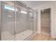 Spacious walk-in shower featuring gray tile surround and a glass door at 623 Leafy Branch Way, Mcdonough, GA 30253