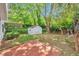 A cozy backyard featuring a shed, patio and mature trees, offering a private outdoor retreat at 912 Third St, Stone Mountain, GA 30083