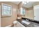 Well-lit bathroom with granite counter, built-in cabinet, and shower/tub combo at 912 Third St, Stone Mountain, GA 30083