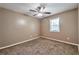 Cozy bedroom featuring plush carpeting, a ceiling fan, and a bright window at 912 Third St, Stone Mountain, GA 30083