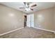Comfortable bedroom with neutral walls, carpet flooring, and a ceiling fan and light at 912 Third St, Stone Mountain, GA 30083