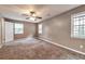 Bright bedroom features a neutral color palette, ceiling fan and plush carpet at 912 Third St, Stone Mountain, GA 30083