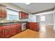 Open kitchen featuring dark wood cabinets, stainless steel dishwasher and fixtures at 912 Third St, Stone Mountain, GA 30083