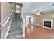 Inviting living room showcasing a fireplace, wood floors, and staircase leading to the upper level at 912 Third St, Stone Mountain, GA 30083