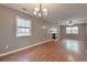 Spacious living room with a fireplace, chandelier, and large windows, offering ample light and comfort at 912 Third St, Stone Mountain, GA 30083
