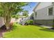 Backyard featuring an artificial lawn, wooden staircase, mature tree, and access to the home at 1068 Shelby Se Pl, Atlanta, GA 30316
