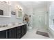 Bathroom with double sink vanity, white hexagon tile floor and frameless glass shower at 1068 Shelby Se Pl, Atlanta, GA 30316