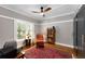 Comfortable bedroom featuring crown molding, hardwood floors, a ceiling fan, and a large window at 1068 Shelby Se Pl, Atlanta, GA 30316