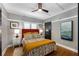 Bright bedroom featuring a ceiling fan, stylish decor, and a sliding barn door at 1068 Shelby Se Pl, Atlanta, GA 30316