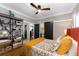 Comfortable bedroom featuring a ceiling fan, stylish decor, and sliding doors to an en suite bathroom at 1068 Shelby Se Pl, Atlanta, GA 30316