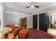 Bedroom featuring crown molding, hardwood floors, a ceiling fan, and sliding doors to an en suite bathroom at 1068 Shelby Se Pl, Atlanta, GA 30316