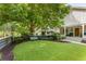 Landscaped front yard with lush green turf and mature trees create an inviting outdoor space at 1068 Shelby Se Pl, Atlanta, GA 30316