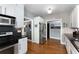 View of the kitchen featuring stainless steel appliances, white cabinets, and hardwood floors at 1068 Shelby Se Pl, Atlanta, GA 30316