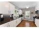 Galley kitchen with stainless steel appliances, granite countertops, and white cabinetry at 1068 Shelby Se Pl, Atlanta, GA 30316