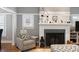 Cozy living room with a fireplace, comfortable seating, and large windows for natural light at 1068 Shelby Se Pl, Atlanta, GA 30316