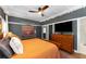 Bedroom with dark gray walls, ceiling fan, a large bed and hardwood floors at 1068 Shelby Se Pl, Atlanta, GA 30316