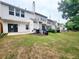 View of multiple backyards and patios in a row with well-kept green lawns at 10900 Wittenridge Dr # H8, Alpharetta, GA 30022