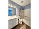 Well-lit bathroom featuring a vanity with sink, toilet, shower with tub, and modern fixtures at 10900 Wittenridge Dr # H8, Alpharetta, GA 30022