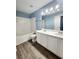 Bright bathroom with double sinks, white cabinets, and a clean, modern design at 10900 Wittenridge Dr # H8, Alpharetta, GA 30022
