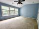 Spacious bedroom with three large windows offering natural light and a ceiling fan at 10900 Wittenridge Dr # H8, Alpharetta, GA 30022
