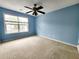 Bedroom with large window that brings in natural light and a ceiling fan at 10900 Wittenridge Dr # H8, Alpharetta, GA 30022