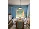 Cozy dining room featuring a wooden table set for six, bright lighting, and a view of the backyard at 10900 Wittenridge Dr # H8, Alpharetta, GA 30022