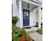 Inviting entrance with a blue front door, white trim, and colorful flowers, providing a warm welcome at 10900 Wittenridge Dr # H8, Alpharetta, GA 30022