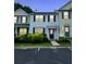 Charming home featuring blue shutters and trim, a well-kept lawn, and ample parking spaces at 10900 Wittenridge Dr # H8, Alpharetta, GA 30022
