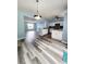 Modern kitchen features white cabinets, stainless steel appliances, and open access to the living area at 10900 Wittenridge Dr # H8, Alpharetta, GA 30022