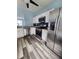 Modern kitchen with stainless steel appliances, granite counters and luxury vinyl flooring at 10900 Wittenridge Dr # H8, Alpharetta, GA 30022