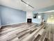 Open-concept living room with modern flooring, fireplace, and seamless flow to the kitchen at 10900 Wittenridge Dr # H8, Alpharetta, GA 30022