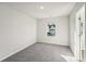 Carpeted bedroom with a window providing ample natural light at 11850 Rizvan Pl, Covington, GA 30014