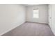 Carpeted bedroom with a window allowing ample natural light at 11850 Rizvan Pl, Covington, GA 30014