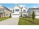 Charming two-story home features a well-manicured lawn, two-car garage, and classic architectural details at 11850 Rizvan Pl, Covington, GA 30014