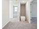 Bright hallway featuring neutral carpeting and access to additional rooms at 11850 Rizvan Pl, Covington, GA 30014