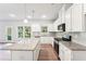 Bright kitchen has stainless steel appliances, granite counters, a center island and a backyard view at 11850 Rizvan Pl, Covington, GA 30014