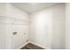 Well-lit laundry room featuring wood-look flooring and wire shelving at 11850 Rizvan Pl, Covington, GA 30014