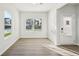 Bright living area with wood-look floors, neutral walls, large windows, and ample natural light at 11850 Rizvan Pl, Covington, GA 30014