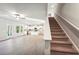 Open-concept living room displaying an open layout and view of the carpeted stairs at 11850 Rizvan Pl, Covington, GA 30014