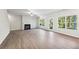 Spacious living room features a fireplace, wood-look floors, neutral walls, and an open layout at 11850 Rizvan Pl, Covington, GA 30014