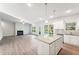 Open floor plan with a modern kitchen, granite countertops, stainless steel appliances, fireplace, and natural light at 11850 Rizvan Pl, Covington, GA 30014